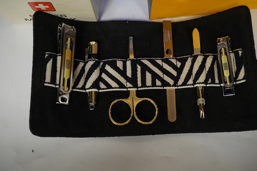 Sundry items comprising, two luxury wallets, boxed, Swiss military lighter and gent's manicure set. Condition - fair